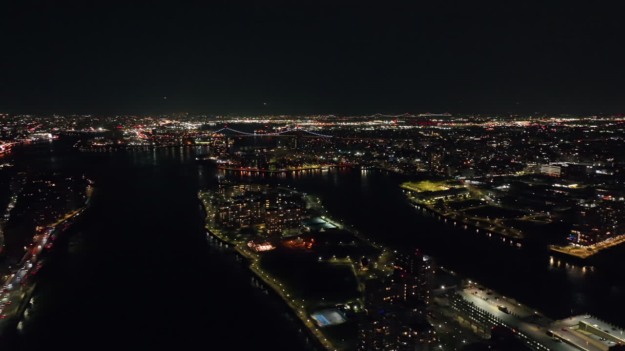 Aerial pan shot of the Queens and Brookly cityscape from Lenox hill, night in NYC