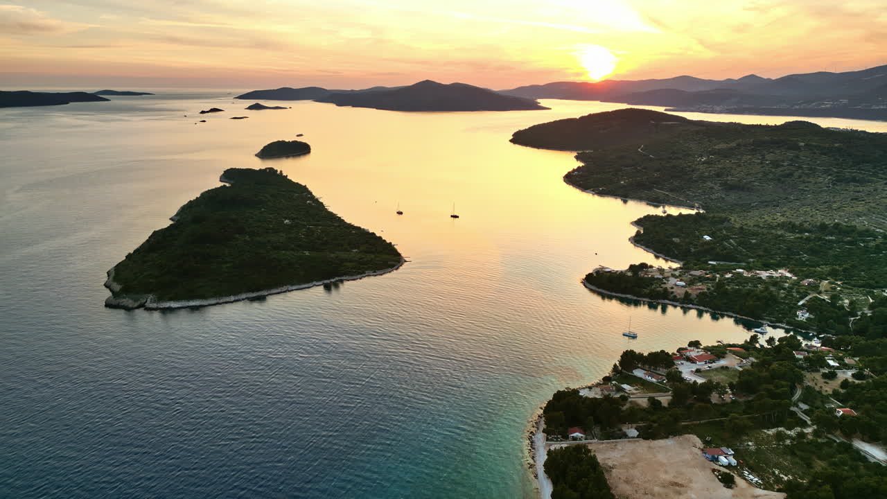 Aerial, drone view of land on the shore of the Adriatic sea in Croatia, at sunset