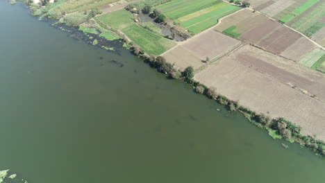 aerial shot for the river nile of egypt in cairo delta surrounded by the green agricultural lands of the nile valley in delta of north egypt