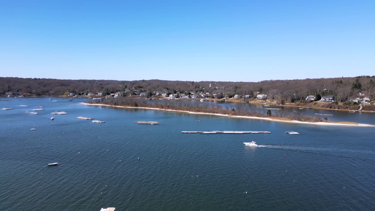 Drone footage of Bird Island between Northport Bay and Centerport Harbor, showing coastal homes, marinas, and the shoreline of Long Island’s North Shore on a peaceful sunny day.