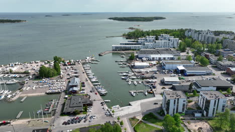 aerial tracking shot of boats at the lauttasaari marina, in sunny helsinki, finland