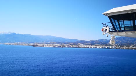 Beautiful-Coastline-View-under-Blue-Sky-and-Calm-Sea-from-Cruise-Ship