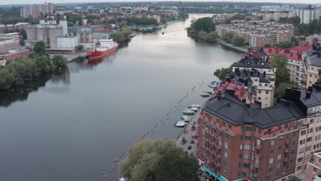 Apartment-buildings-by-canal-during-sunset-in-Södermalm,-Stockholm,-Sweden