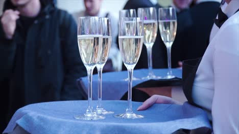 champagne glasses being served at an event