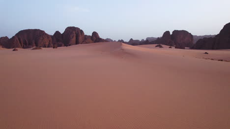 sahara desert and sandstone cliffs at dawn in tassili n'ajjer national park, illizi, algeria