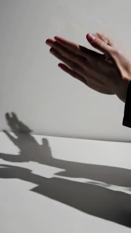 hands clapping with shadows