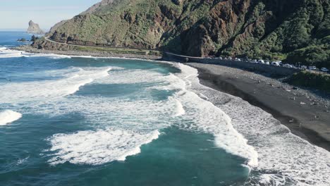 static aerial view of the waves breaking at the beach