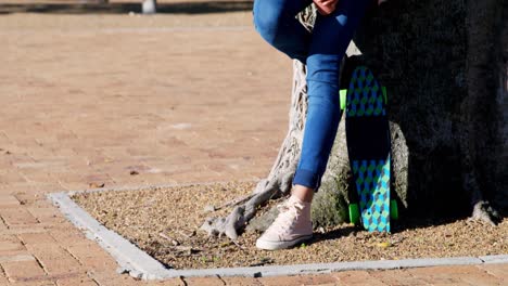 Woman-using-mobile-phone-while-having-juice-in-park-4k