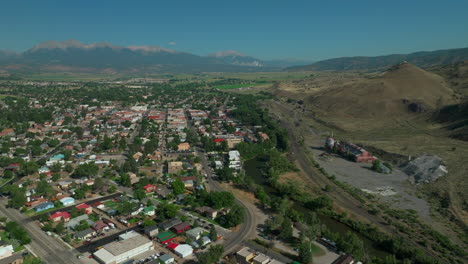 aerial cinematic drone mid summer downtown salida s lime mill colorado near buena vista on arkansas river riverside park scout surfing wave biking hiking rafting rocky mountain up high up movement