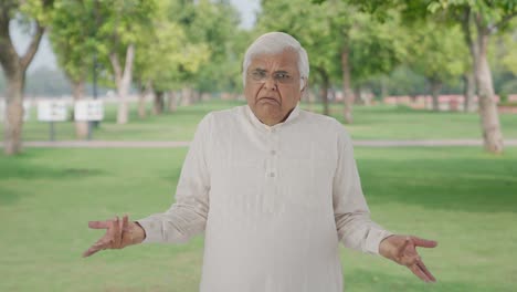 Confused-Indian-old-man-asking-what-question-in-park