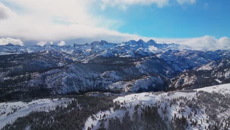 winter spring mammoth mountain ski resort california hemlocks ritter range sierra nevadas minarets summit vista sunny blue sky snowy clouds over jagged peaks inyo sierras national forest forward pan