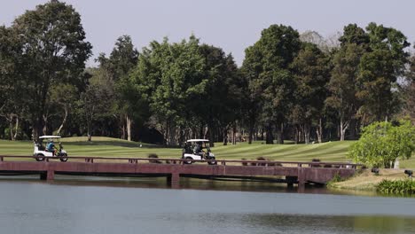 golf cart moves across bridge over water