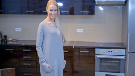 smiling blond woman posing at the kitchen