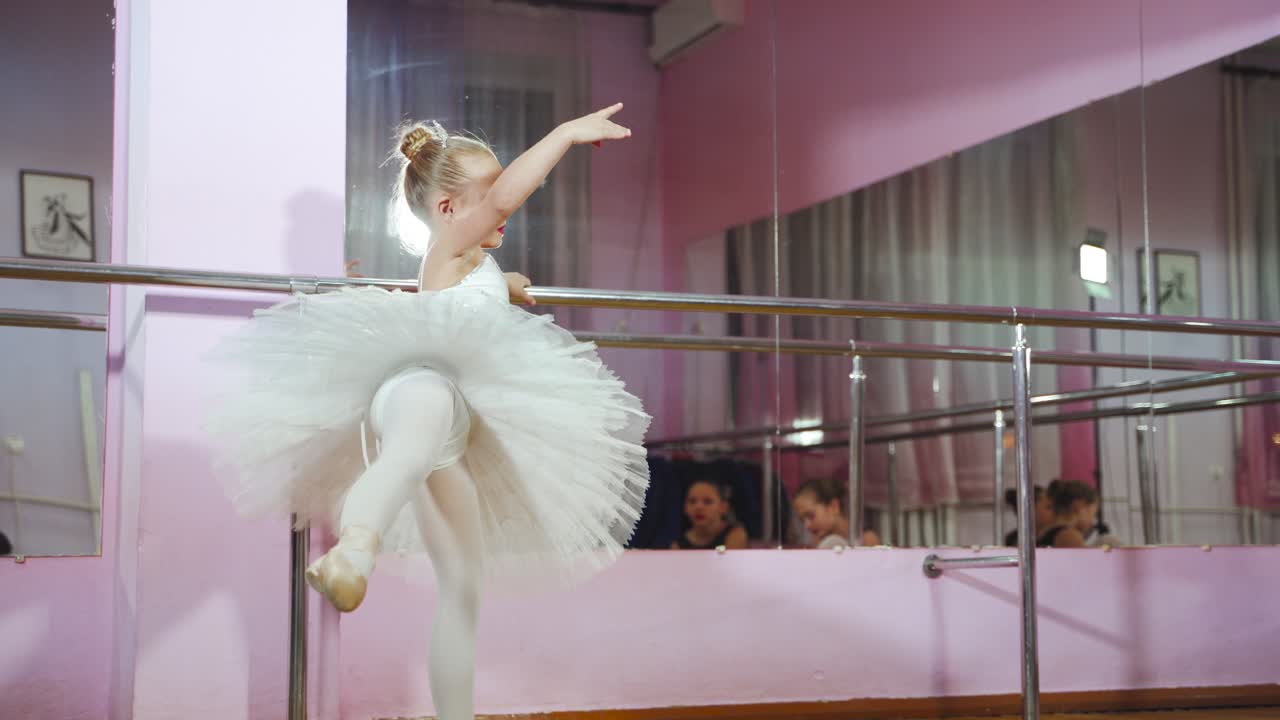 Ballet. Cute ballerina dancing in the studio. Beautiful young dancer. A ballerina is posing.