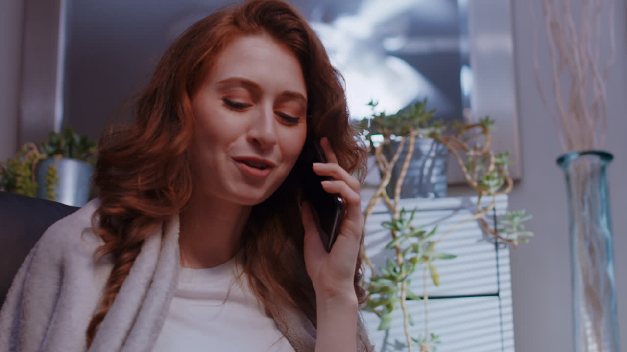 A young caucasian woman is talking on her cell phone, with attitude and girly sass