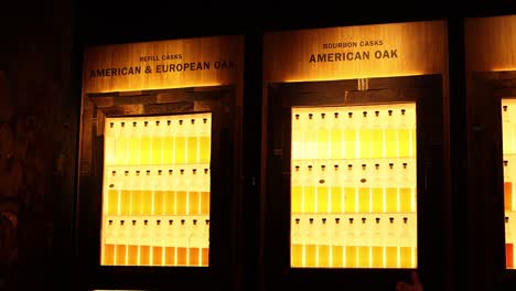 illuminated whisky bottles in a display case