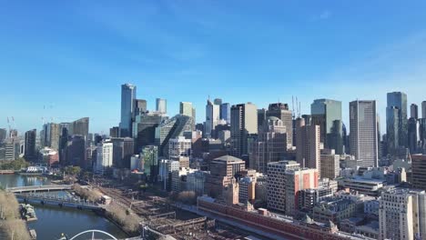 aerial rise up over the yarra river flinders street station and rail yards