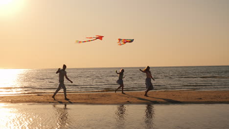 a young family actively spends time together - they play kites