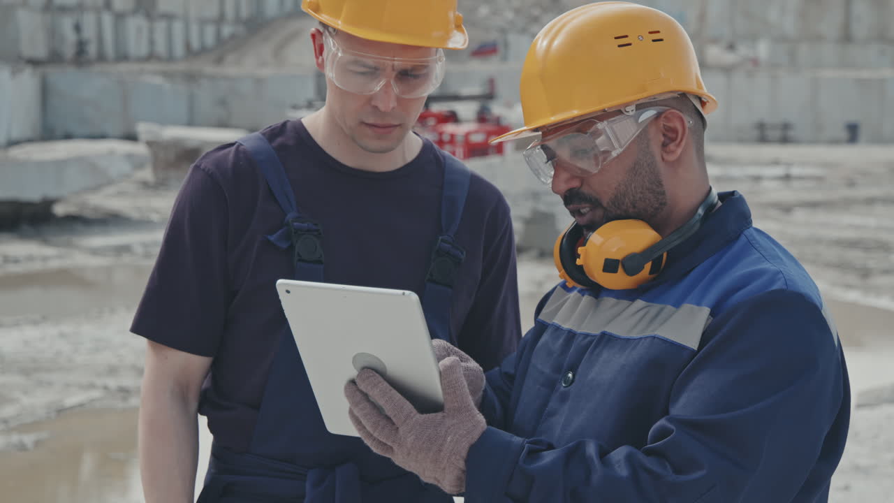 Male Workers with Tablet Talking in Quarry