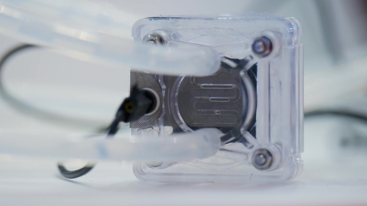 Transparent electrolysis device producing hydrogen bubbles inside laboratory setup for green energy research and future clean fuel technology