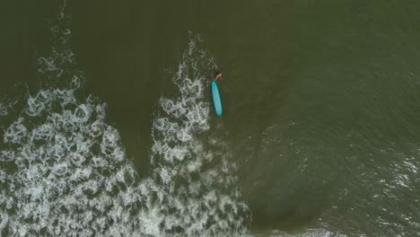 Birds-eye-view-of-female-surfer-in-the-Gulf-of-Mexico-off-the-coast-of-Lake-Jackson-in-Texas