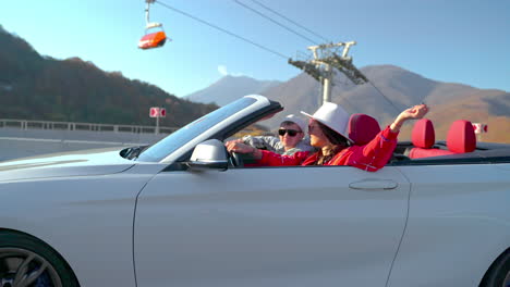 couple enjoying a scenic drive in a convertible car