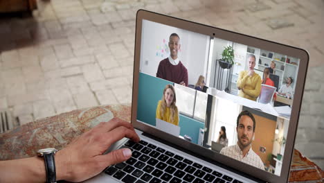 man having a video conference with multiple people