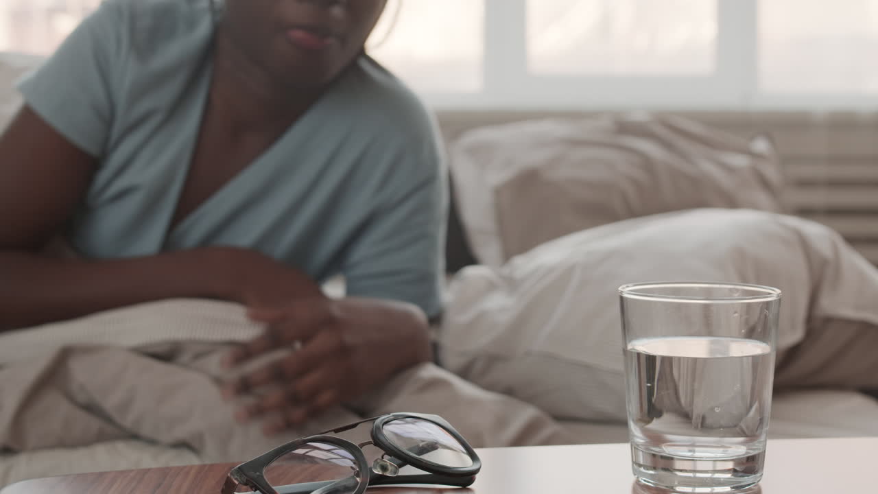 Woman Waking up and Drinking Water