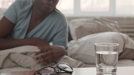 woman waking up and drinking water