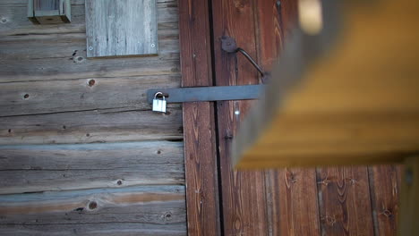 truck reveal of wooden shed door locked by padlock