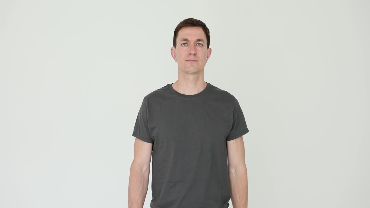 Portrait of a Man in a Grey T-shirt on a White Background