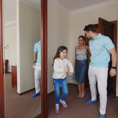 a young family enter hotel room