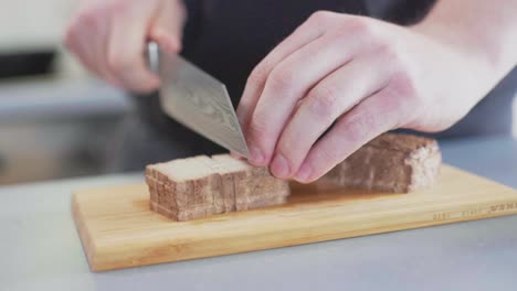 smoked tofu being sliced into cubes