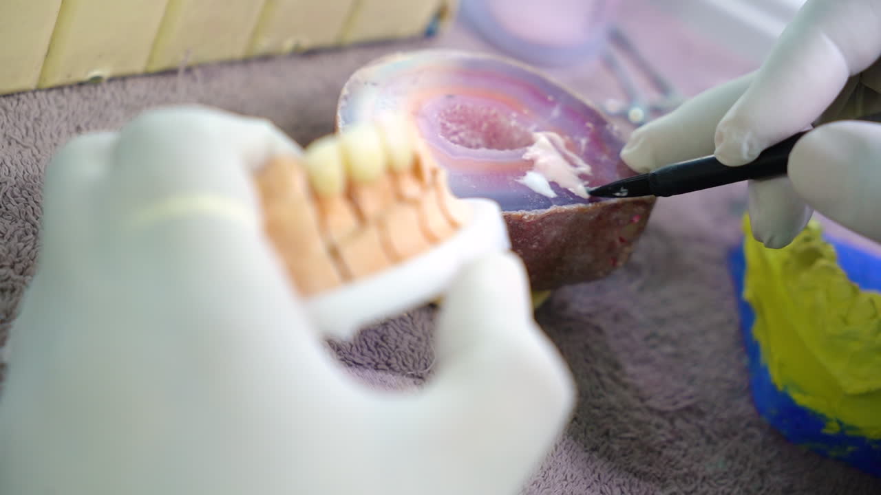 disparo estático de una impresión dental de dientes siendo esculpida dentro de un laboratorio dental