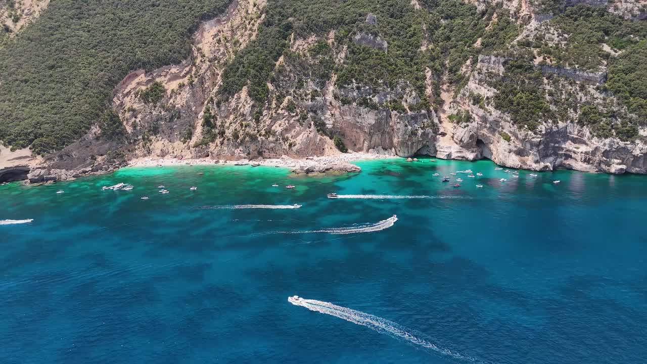 Aerial view of Cala Mariolu beach in Sardinia with boats and clear water