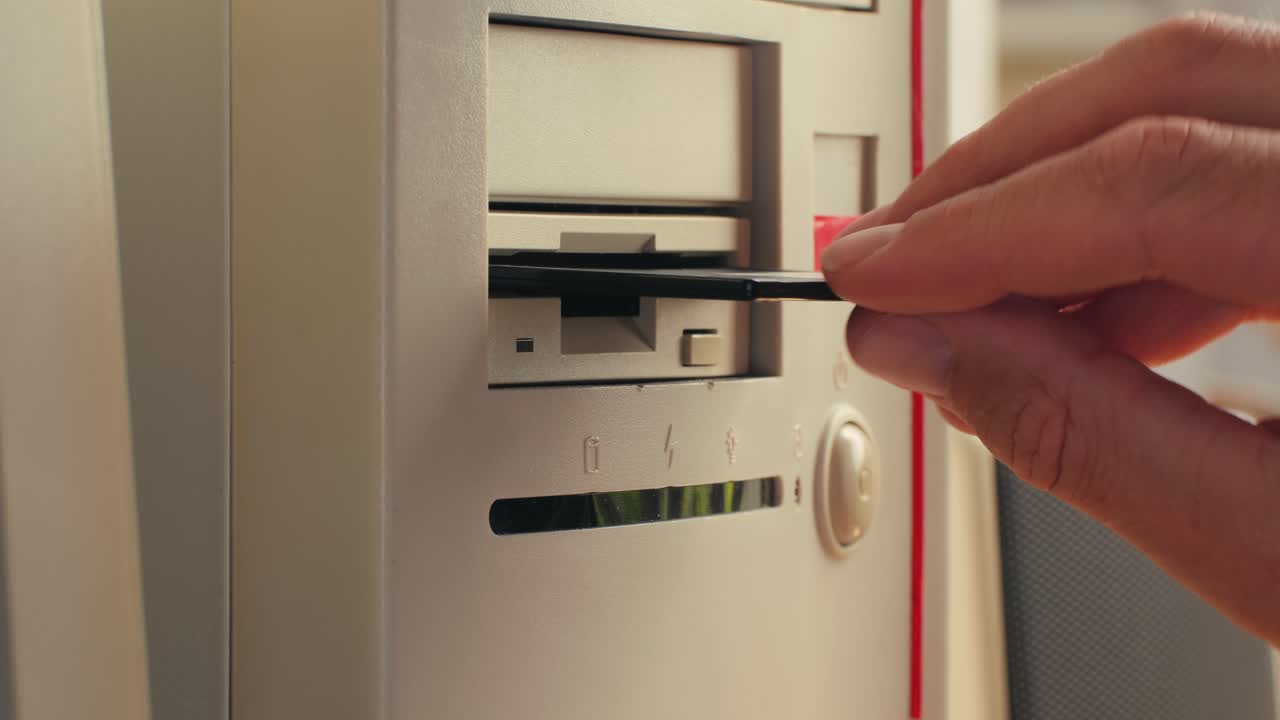 Using diskette for old computer. Music recorder, playing retro computer games. Vintage device for office, obsolete technology. . High quality 4k footage