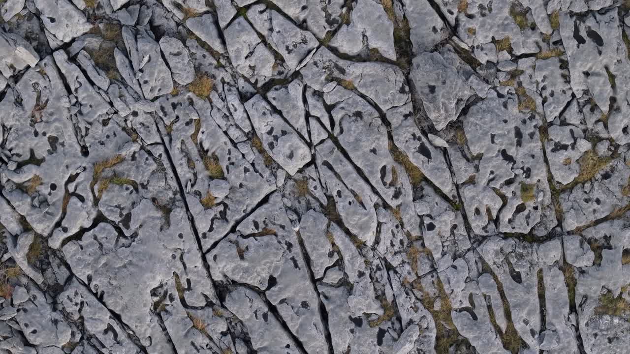 Karst Landscape Of The Burren With Moon-like Appearance. County Clare, Ireland. aerial topdown, pullback ascend