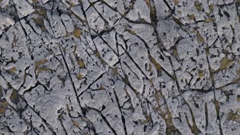 karst landscape of the burren with moon-like appearance. county clare, ireland. aerial topdown, pullback ascend