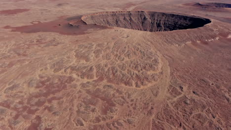 aerial view of a volcanic crater in a desert landscape