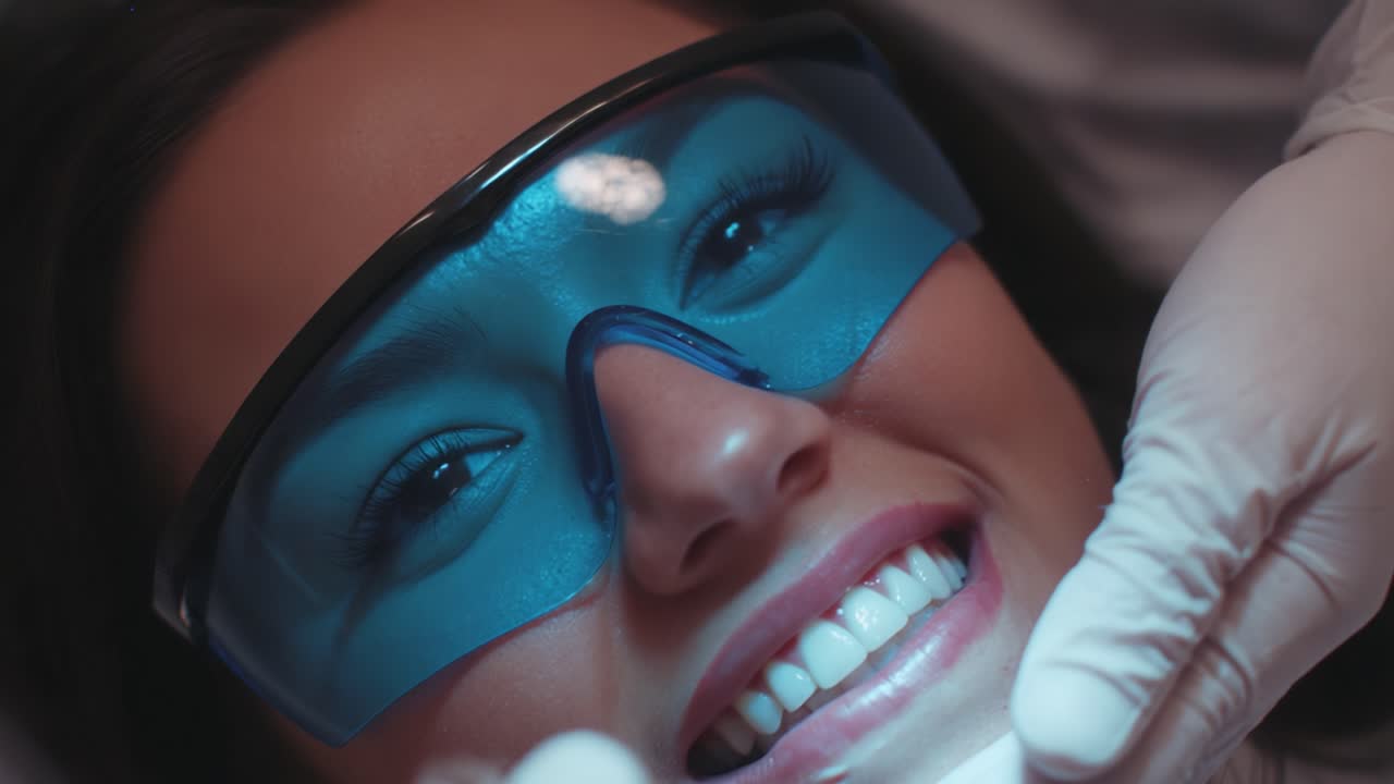 A Close-Up View of a Patient Enjoying a Dental Procedure: Bright Smile, Protective Eyewear, and Relaxed Atmosphere Highlight the Comfort of Modern Dentistry