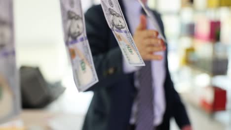 person holding a hundred dollar bill hanging on a clothesline, symbolizing money laundering