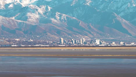 Salt-Lake-City,-Utah-as-seen-from-across-the-Great-Salt-Lake-in-winter