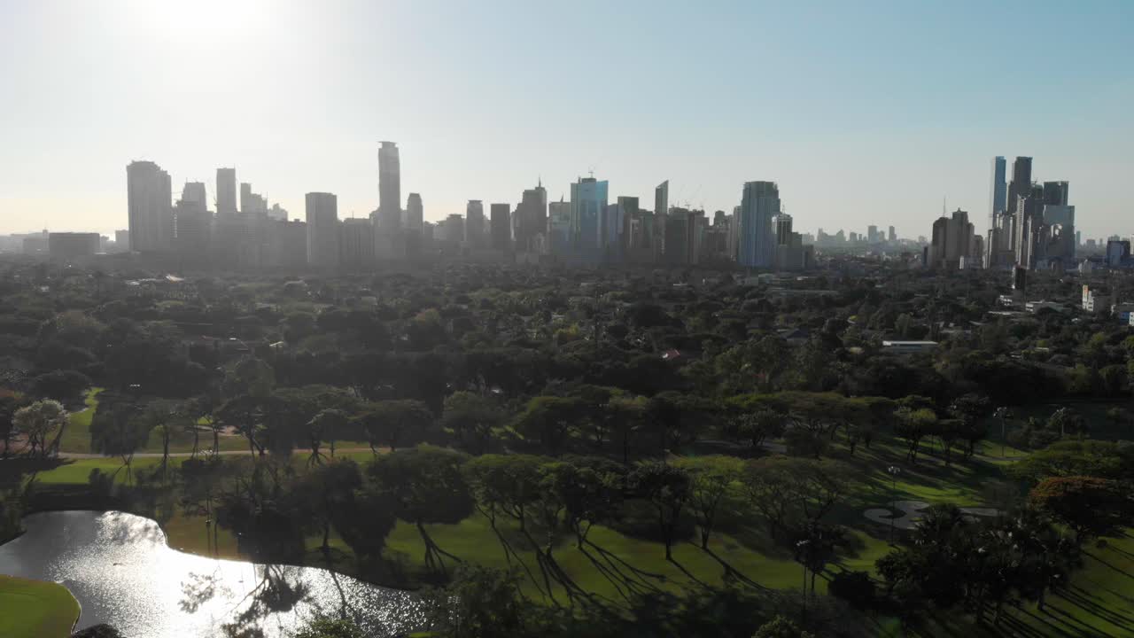Manila City Skyline and Lush Green Park - Aerial View