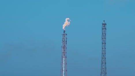 two closeup view of an industrial burner in a refinery