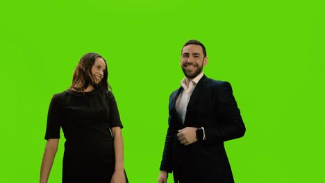 slowmotion. two business partners shaking hands and hugs against green screen background, chroma key, 4k pre-keyed footage