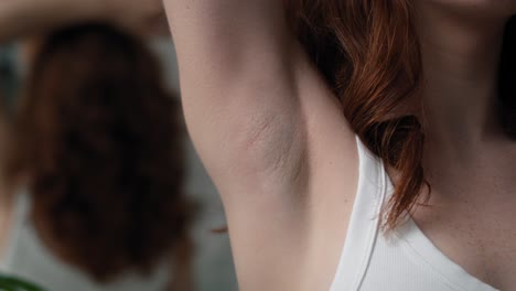 close up of woman with applying antiperspirant.