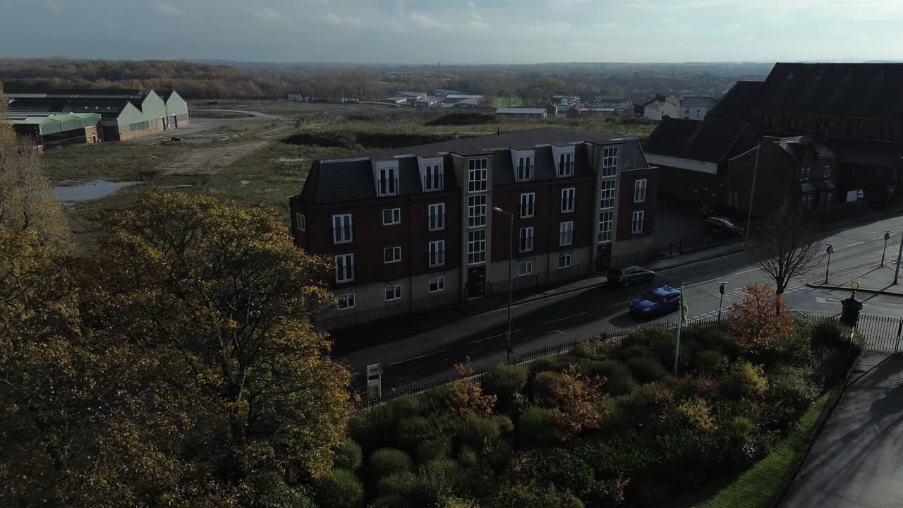 Aerial hyper lapse circling HMO development accommodation properties silhouetted at sunrise