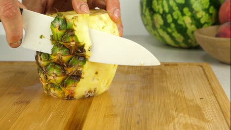 skinning a pineapple with a sharp ceramic knife