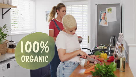 animation of 100 percent organic text over diverse female couple cooking at home