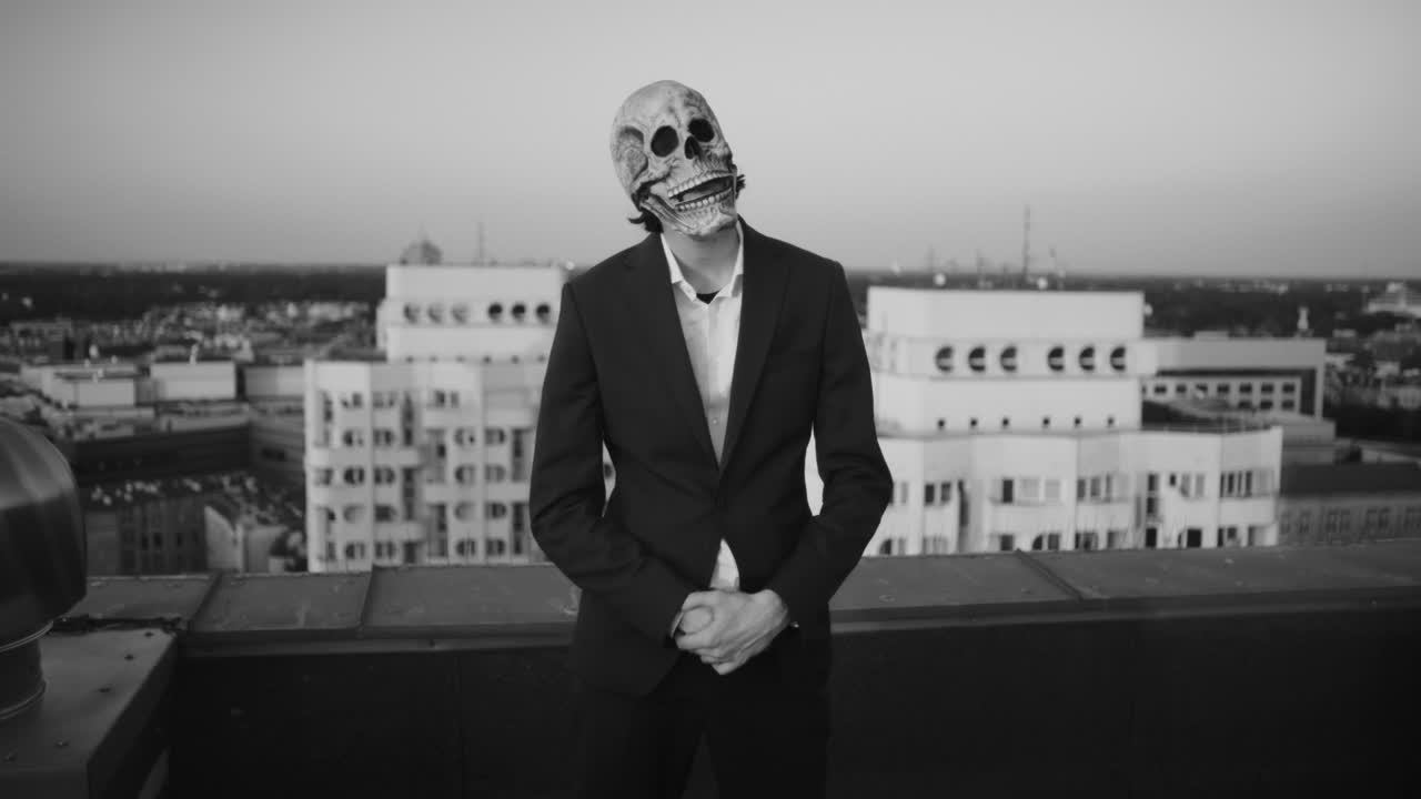Person in Skull Mask on Rooftop Overlooking City